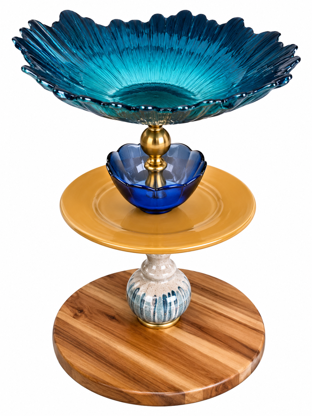 The Maylan tiered serving tray with teal sunburst glass top bowl, cobalt blue flower accent, mustard yellow ceramic plate, glazed ceramic stem, and striped wood base